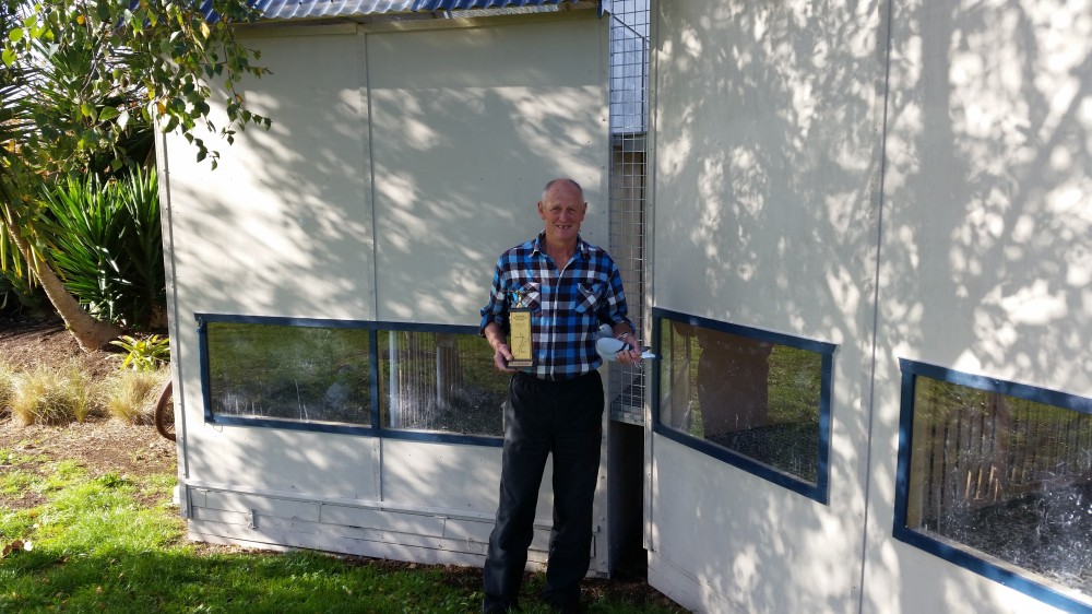 Steve Archer outside the Archer's new loft at their new residence (looks impressive!) holding their 2013 ARPF Timaru winner and trophy it won.